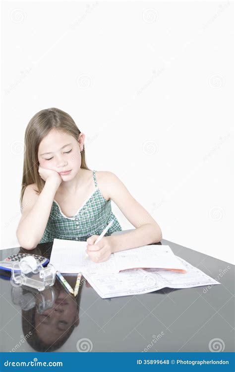 Cute Girl Studying At Table Over White Background Stock Photo Image