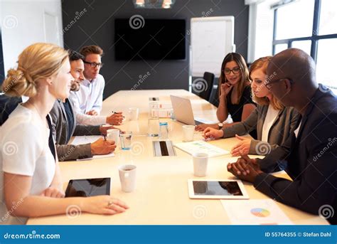 Group Of Executives Having Meeting In Conference Room Stock Photo