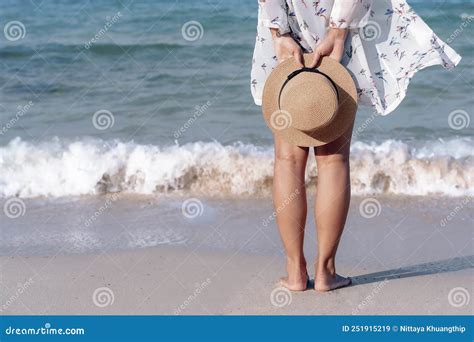 Back View Of Woman S Legs Standing On Sandy Beach Near Turquoise