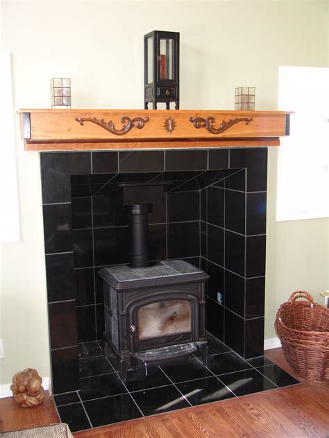 The stove i have no idea ours is a monster brick lined set it in with a forklift. Wood stove + Fireplace tile | Flickr