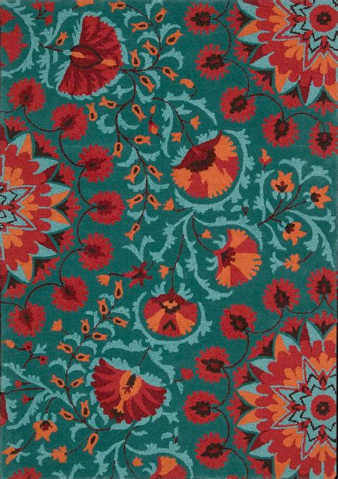 An Area Rug With Red And Blue Flowers On Green Ground In Front Of A