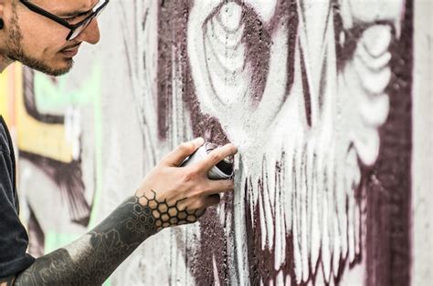 Premium Photo Tattoo Graffiti Writer Painting With Color Spray His