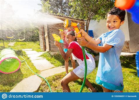 Boy With Strong Face Expression In Water Gun Fight Stock Image Image