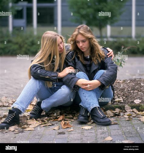 Sad Teenage Girl Is Comforted By A Teenage Girlfriend Stock Photo