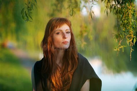 Young Redhead Caucasian Woman Serious Face Outdoor Portrait In Film