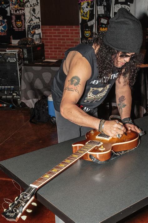 Grammy Award Winning Rockstar Slash Signs Guitar At Hard Rock Hotel