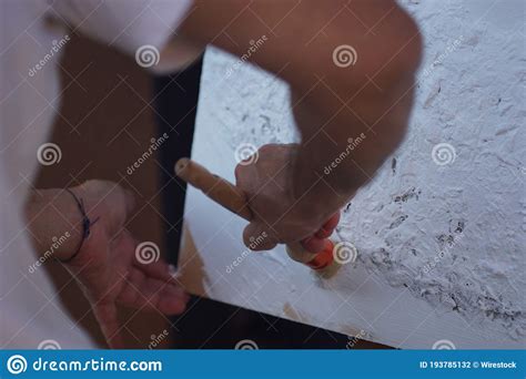Closeup Of A Professional Artist Painting The Canvas With White Paint
