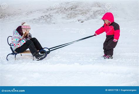 Little Baby Girl In Pink Pulling A Sled With Sister Stock Photo Image