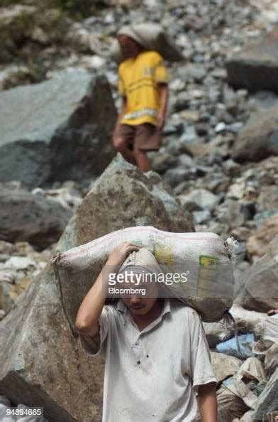 Workers Carry 45 Kilogram Bags Of Raw Ore From A Mineshaft On Mount