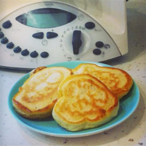 Three Pancakes On A Blue Plate Next To An Electric Toaster