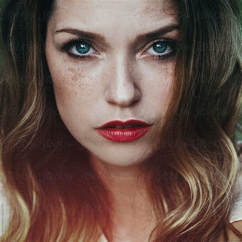 Artistic Portrait Of A Beautiful Young Woman With Freckles And Blue Eyes By Stocksy