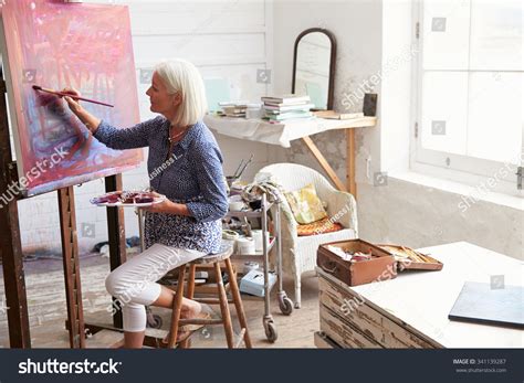 Stock Photo Female Artist Working On Painting In Studio 341139287
