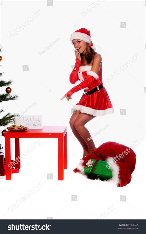 Sexy Ms Santa Claus Standing By The Christmas Tree With Milk And