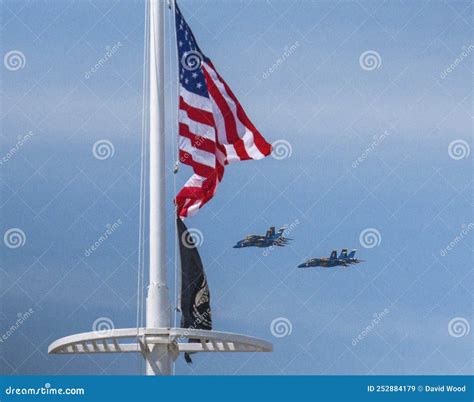 Four Us Navy Blue Angels Jets Flying In Formation Behind An American
