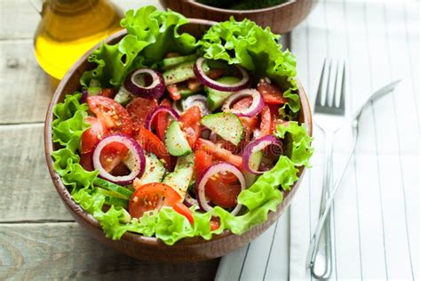 Rustic Salad Of Fresh Tomatoes Cucumbers Red Onions And Lettuce
