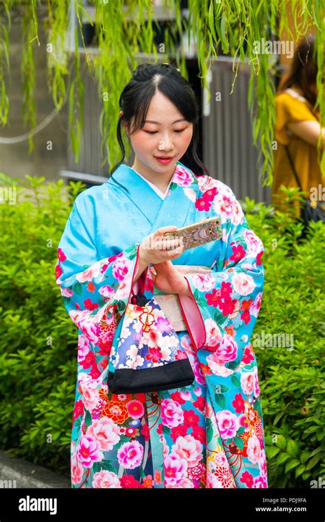 Japanese Woman In Traditional Kimono Posing For Selfie Photo In Kyoto