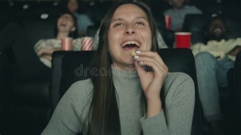 Cheerful Girl Laughing Watching Movie In Cinema Eating Popcorn Having