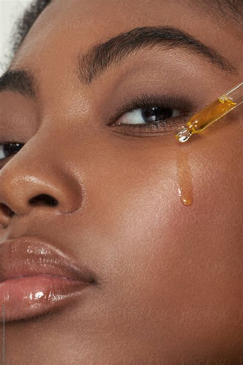 Model With Face Serum Dripping On Face By Stocksy Contributor Hannah Criswell Stocksy