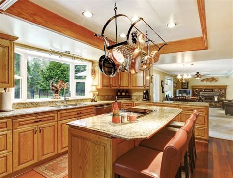 This ceiling mounted wooden pot rack features 2 incandescent bulbs for better visibility during evening cooking. 5 Convenient Kitchen Island Ideas