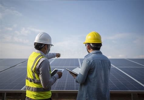 Engineer And Worker Working Together In The Solar Panel Power Station