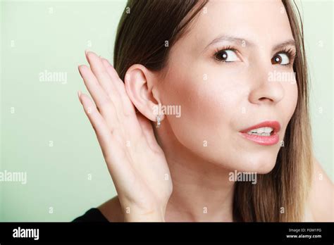 Female Hand To Ear Listening On Green Gossip Girl With Palm Behind Ear