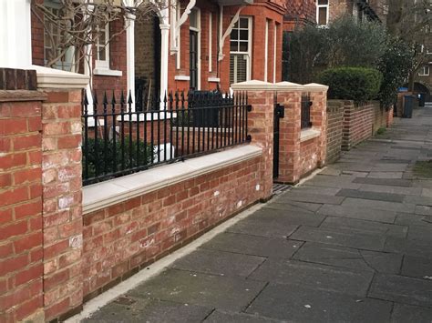 Pretty West London Red Brick Front Wall With Stone Effect Caps And Iron