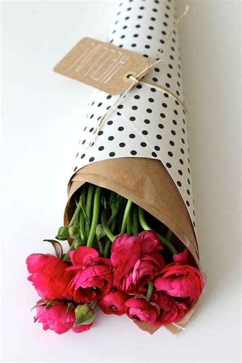 Flowers First Wrapped In Brown Paper Then Wrapping Paper With A Tag