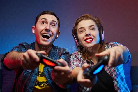 Portrait Of Crazy Playful Couple Gamers Enjoying Playing Video Games