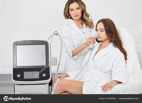 Doctor Doing Rf Lifting Procedure For Young Woman Sitting In A Beauty