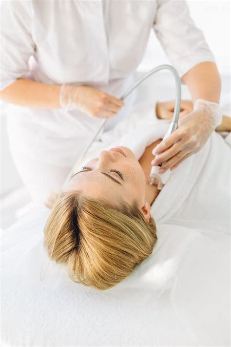 Woman Having A Stimulating Facial Treatment From A Therapist Stock