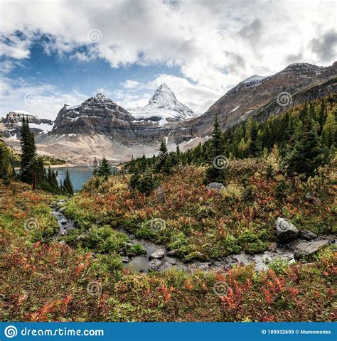 Mount Assiniboine With Lake Magog On Autumn Forest At Provincial Park