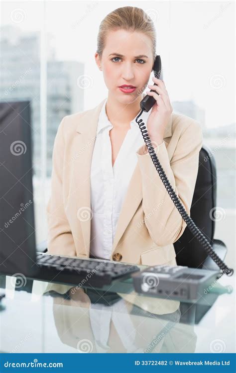 Frowning Pretty Businesswoman Answering The Phone Stock Photo Image