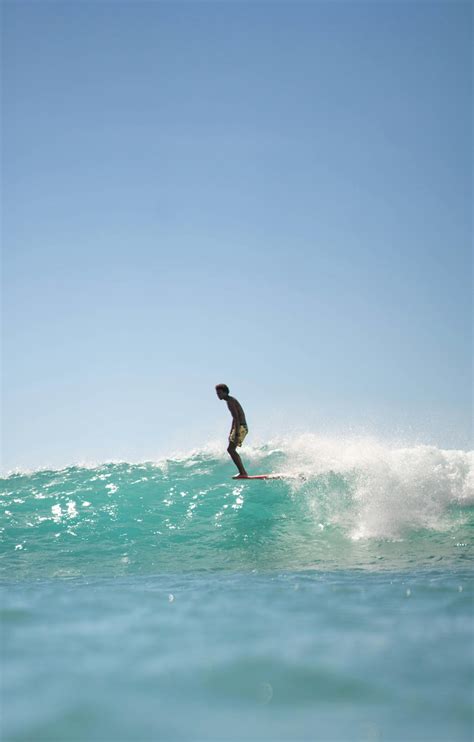 Photo Of Man Surfing On Ocean · Free Stock Photo