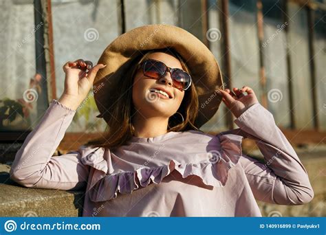 Outdoor Portrait Of Happy Tanned Model Wears Hat And Sunglasses
