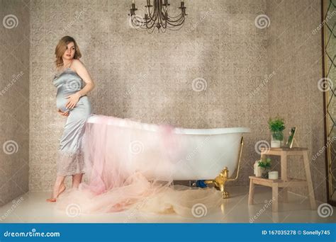 Pregnant Woman In The Bathroom Close Up Pregnant Near The Bath In A Gray Peignoir And Copy