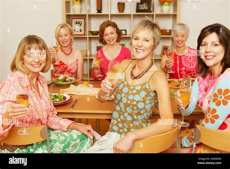 Portrait Of A Group Of Mature Women Sitting At The Dining Table And