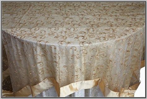 The Table Cloth Is Gold And Has Swirls On It