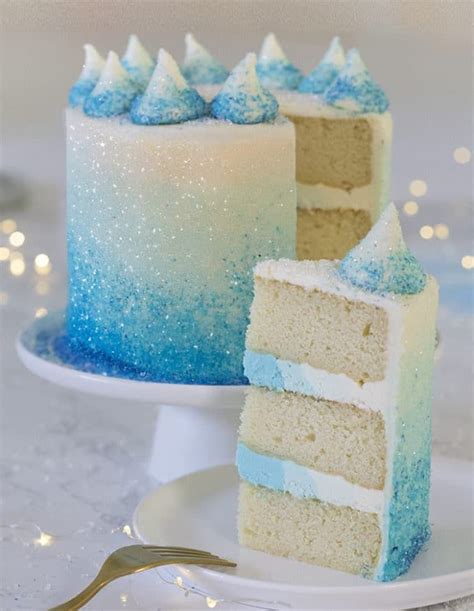 A Photo Of A Blue Ombre Cake With A Piece In The Foreground Frozen