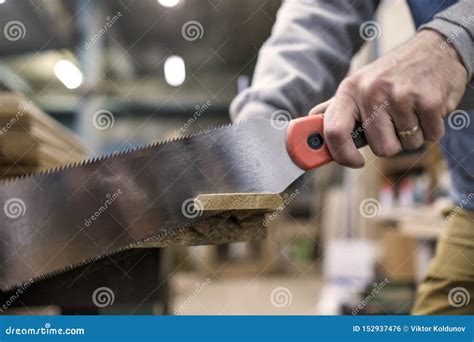 Sawing A Wooden Board With Special Japanese Hand Saw Or Hacksaw During