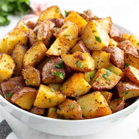 In a large bowl, toss the potatoes, olive oil, garlic, salt, pepper, thyme, oregano, basil and parmesan cheese until evenly coated. Garlic Parmesan Roasted Red Potatoes with Video • Bread ...
