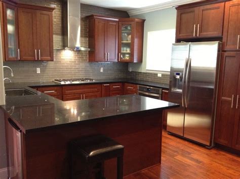 We left the walnut cabinets as is. grey glass subway tile backsplash with cherry cabinets and ...