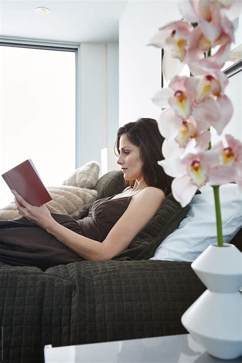 Woman Reading A Book In Bed By Stocksy Contributor Trinette Reed Stocksy