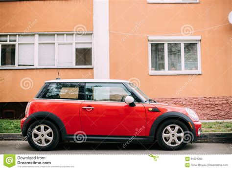 Red Color Car Mini Cooper Parked On Street Near Residential House
