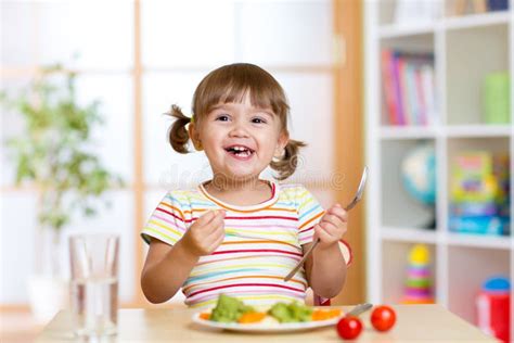 Happy Child Girl Eating Vegetables Healthy Nutrition For Kids Stock