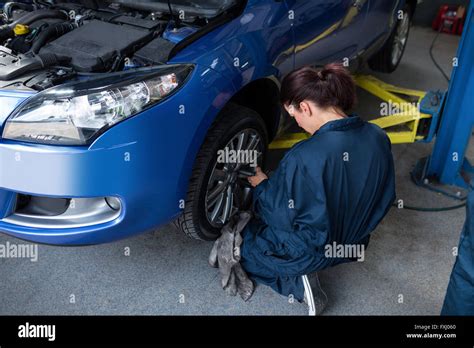 Female Mechanic Fixing A Car Wheel Stock Photo Alamy