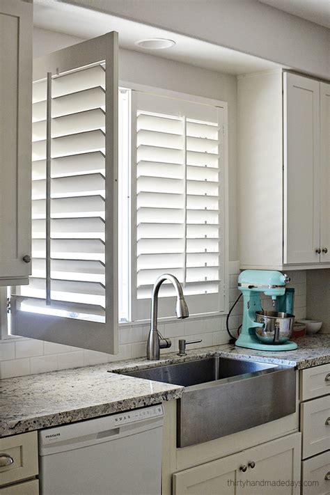 Shutters On Window Over Kitchen Sink With One Panel Open Window