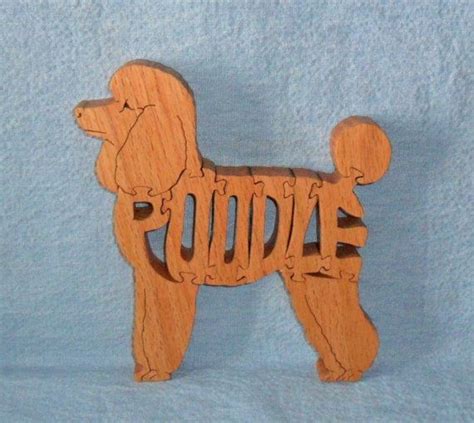 A Wooden Toy Dog With The Word Poodle On Its Chest And Tail