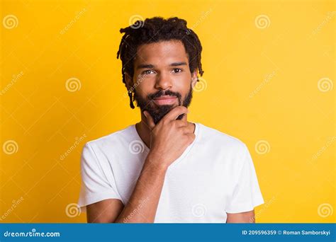 Photo Of Clever Dark Skin Guy Look Camera Hold Arm On Chin Wear Casual