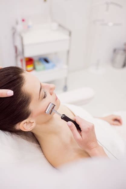 free photo dermatologist performing laser hair removal on patient