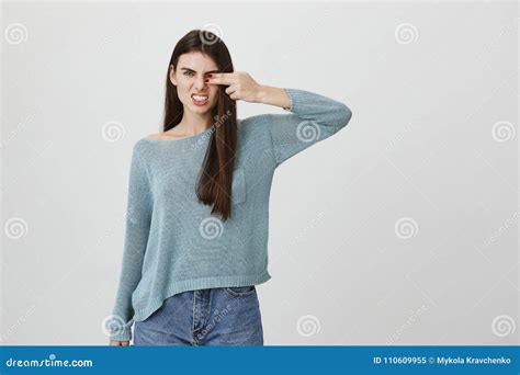 Portrait Of Aggressive Woman With Frowned Eyebrows Covering One Eye
